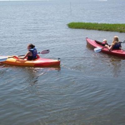 a group of people in a small boat in a body of water