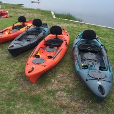 a boat sitting on top of a grass covered field
